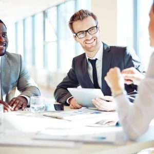 Smiling colleagues discussing working ideas in office